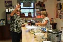 Garry helps Pat in the kitchen.