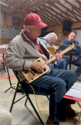 Robert Cheatwood and his self-made cigar box guitar